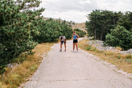 A romantic couple enjoys a serene moment of rest and affection after their morning run, basking in the glow of their shared fitness journey