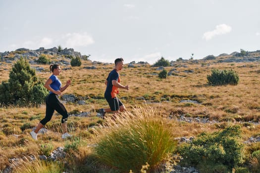 Couple conquer challenging mountain trails during an invigorating morning run.