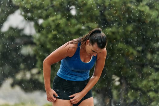 A determined female athlete is captured in preparation mode for her morning run, showcasing dedication and focus in her fitness routine