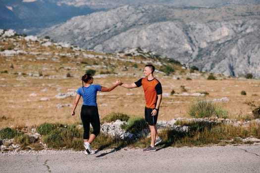 A jubilant couple celebrates their triumphant finish after a challenging morning run, exuding happiness and unity amidst the refreshing outdoor scenery.