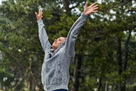 A stunning woman savors the tranquility of a rainy day after a rigorous run, finding solace and rejuvenation in the soothing rhythm of the falling rain.