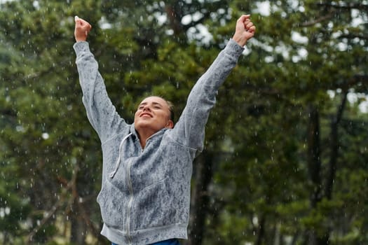 A stunning woman savors the tranquility of a rainy day after a rigorous run, finding solace and rejuvenation in the soothing rhythm of the falling rain.