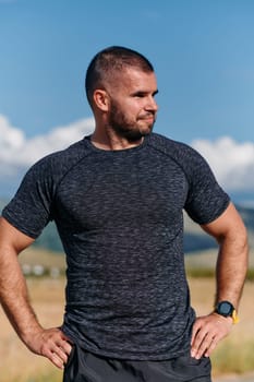 An athletic man checks the results of his run on a smartwatch, leveraging technology to monitor his performance and progress in his fitness journey