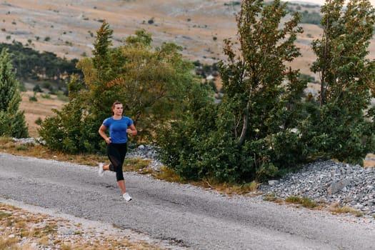 A determined female athlete runs through a forest trail at sunrise, surrounded by breathtaking natural beauty and vibrant greenery.