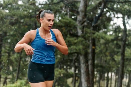 Rain or shine, a dedicated woman powers through her training run, her eyes set on the finish line.