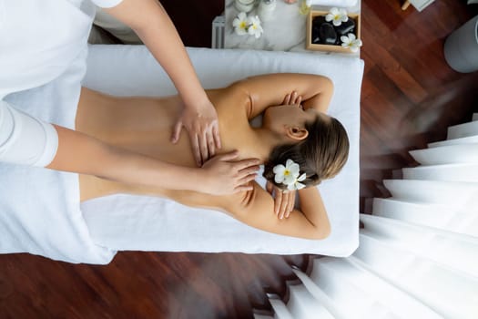 Panorama top view woman customer enjoying relaxing anti-stress spa massage and pampering with beauty skin recreation leisure in day light ambient salon spa at luxury resort or hotel. Quiescent