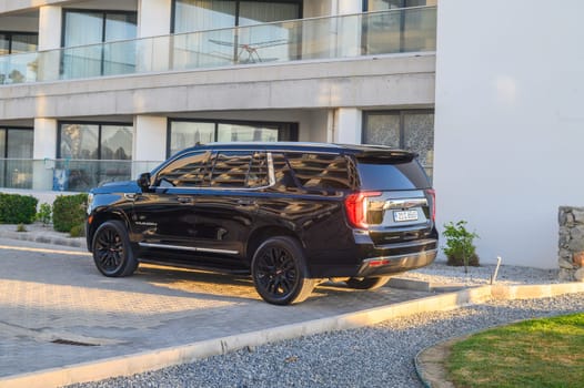 Gaziveren Cyprus 05.27.2024 - black GMC Yukon in the parking lot outside the house 3