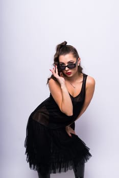 Fashion portrait of beautiful model in a dress with sunglasses