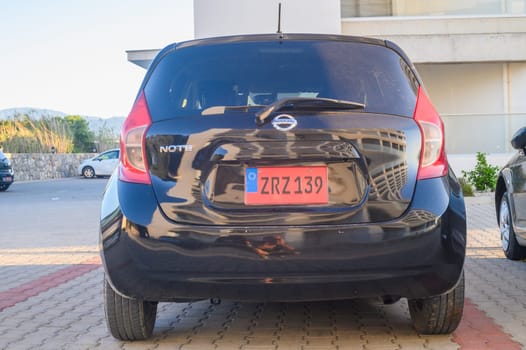 Gaziveren Cyprus 05.27.2024 - black Nissan Note in the parking lot outside the house 1