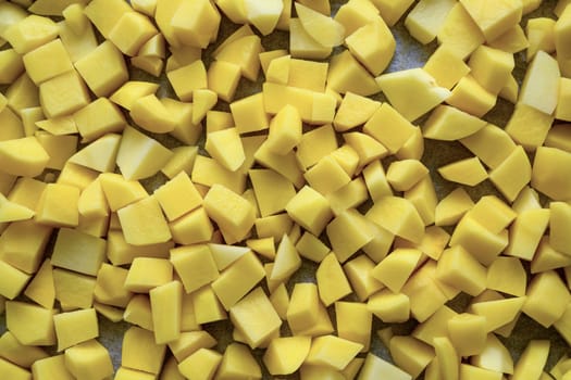 Top view of potatoes being diced for frying