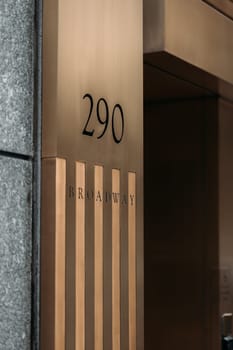 Close-up view of the entrance to 290 Broadway in New York City, showcasing sleek modern architecture.