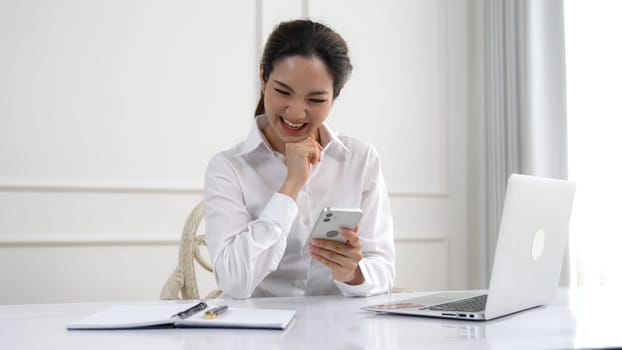 Young woman using smartphone browsing for online shopping E commerce by online payment gateway at vivancy home. Modern and convenience online purchasing make secure and convenient purchases.