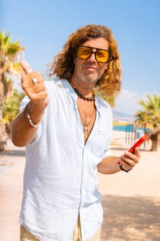 Caucasian man wearing sunglasses feeling smiling showing his finger up in disapproval outdoors.