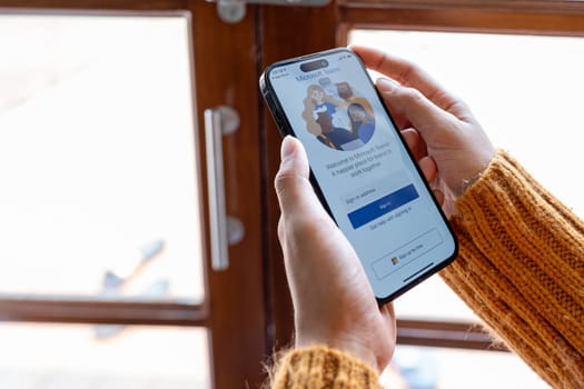 30 April 2023 Chiangmai, Thailand : Woman holding smartphone mobile show Microsoft Teams social platform, group chat platform app.