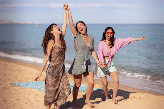 Cheerful multiethnic friends with sunglasses happy on vacation on the beach, looking at the camera.