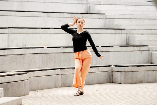 Sweet Girl Dances In Sandals At Amphitheater In Summer