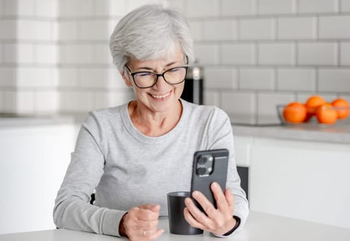 Charming Senora Is Having A Video Call In Kitchen