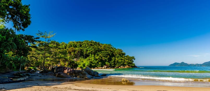 Castelhanos beach with sea,  forest and mountains on the island of Ilhabela in Sao Paulo