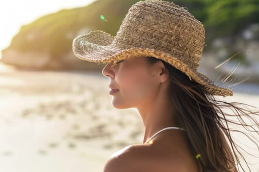 Woman in straw hat standing on beach with ocean background enjoying travel and beauty of nature concept