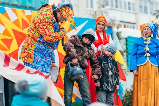 VICHUGA, RUSSIA - FEBRUARY 17, 2018: Contests and entertainment on stage at the traditional winter Russian Slavic celebration of the Maslenitsa holiday