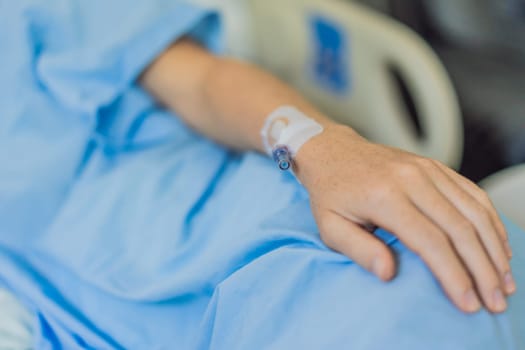 A woman in the hospital has a catheter inserted into her arm for IV drips. The medical procedure is performed to administer fluids, medication, or nutrients directly into her bloodstream, ensuring proper treatment and care.