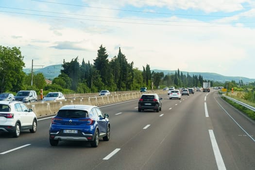 Valence, France - May 7, 2023: A group of cars driving together on a road, moving in the same direction with traffic.