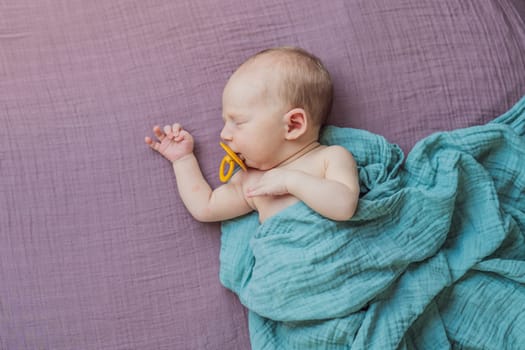 The baby is sleeping peacefully in his cozy nest. Newborn photo session captures the serene innocence and warmth of early moments.