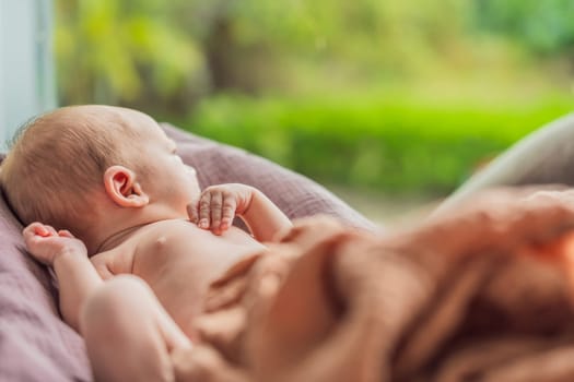 A newborn lies in his cozy cocoon on muslin swaddles. This serene moment captures the comfort and security of a newborn, highlighting the gentle care and nurturing environment.