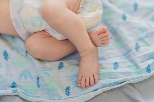 The newborn's skin is peeling. Mom uses skin products and massages to care for and soothe the baby's delicate skin, ensuring comfort and promoting healthy skin.