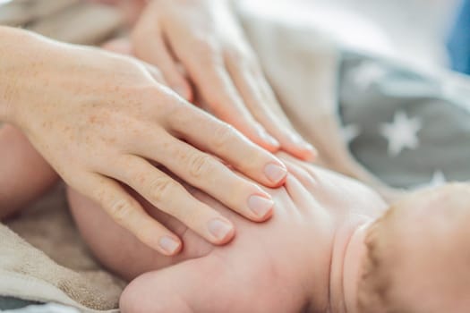 The newborn's skin is peeling. Mom uses skin products and massages to care for and soothe the baby's delicate skin, ensuring comfort and promoting healthy skin.