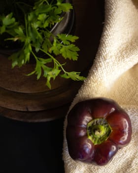 Zenithal picture of dark purple pepper .Concept of healthy food. Still life image. Dark background