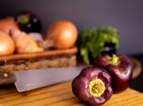 Harvested vegetables in a basket on wooden table. Concept of healthy food. Still life image.Horizontal photo.