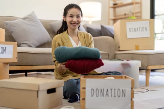 Volunteers donating clothes, showcasing community service and social responsibility. Concept of generosity, kindness, and support through clothing donations.