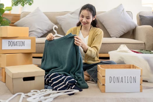 Volunteers sorting and donating clothes for charity, showcasing community service and generosity in action.