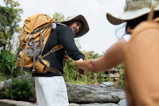 Enthusiastic hikers enjoying a scenic outdoor adventure, equipped with backpacks, exploring nature, and engaging in travel and hiking activities.