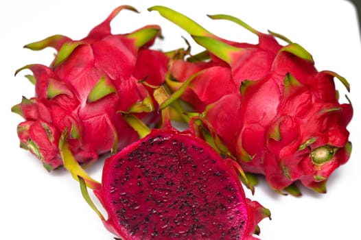 Delicious cut and whole dragon fruits (pitahaya) on white background 1