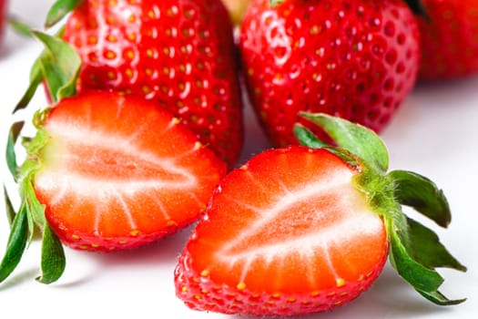 Set of ripe whole strawberries and cut strawberries isolated on white background. 2