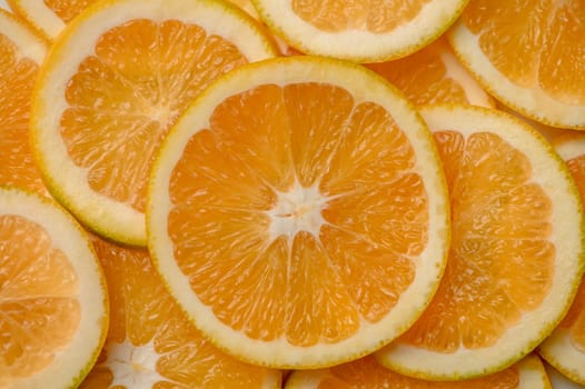 Sliced orange circles, laid on the surface in several layers. Tropical background for design and web 3