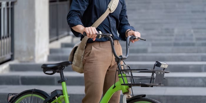 Businessman riding a bicycle to work, promoting eco-friendly transportation and sustainable urban living.