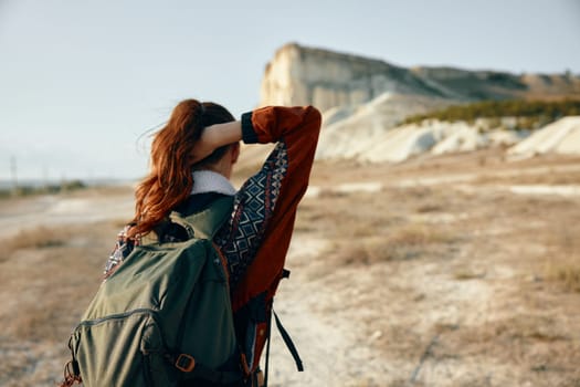 Adventurous woman gazing at majestic mountain peaks on a clear day