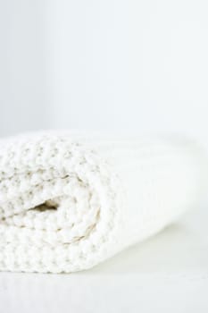 Knitwear, fabric textures and handmade items concept - Warm knitted clothes, soft and white