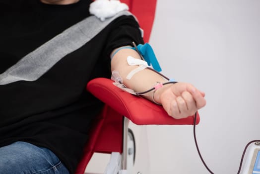 Laboratory and blood analysis concept. Close up cropped shot of professional nurse in gloves, taking a blood sample from arm vein of young female patient