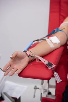 view of donor giving blood at donation center.