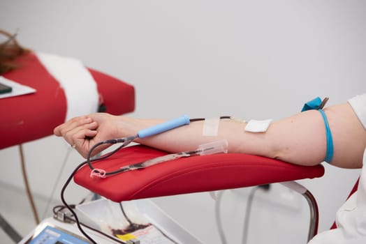 view of donor giving blood at donation center.