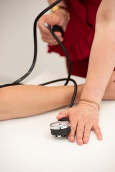 Doctor checking patient arterial blood pressure. Health care.