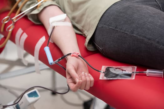 view of donor giving blood at donation center.