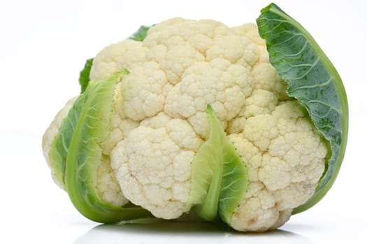 Whole head of the fresh raw cauliflower with some leaves close-up on a white background 2