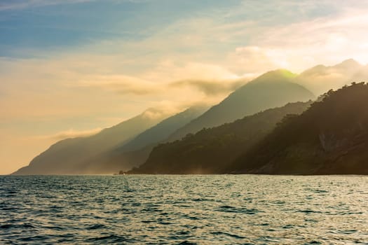 Big mountains, forests and sea on the island of Ilhabela on the north coast of Sao Paulo during sunset