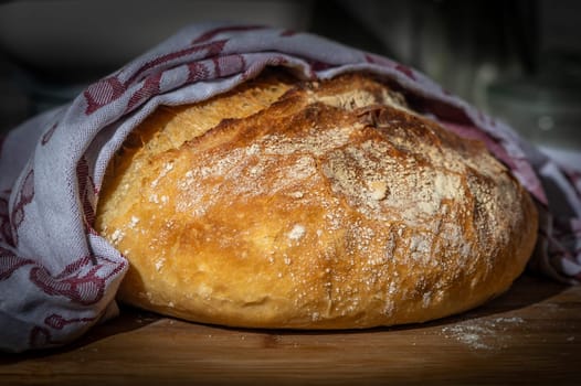 Freshly baked bread on rustic wooden background.1