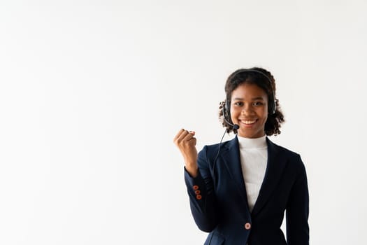 Smiling female call center employee wearing a headset and business attire, showcasing professionalism and customer service.